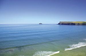 a body of water with a group of people in the water at St Moritz Hotel and Cowshed Spa in Polzeath