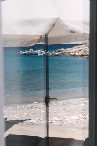 a view of a beach with a boat in the water at Anastasia Kimolos in Kimolos