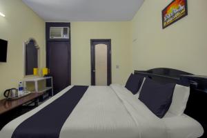 Postel nebo postele na pokoji v ubytování Hotel O Malhotra BnB + 33 fotografií