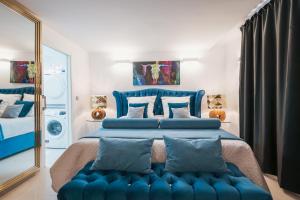 a bedroom with a blue bed and a mirror at BS Luxury Estate El Campello in El Campello +68 photos