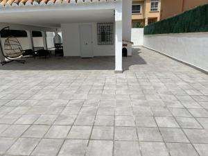 a patio with a table and chairs in a building at Beachfront vila in Valencia