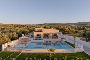 an aerial view of a house with a swimming pool at Bliss Villas in Rethymno Town