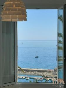 a view of the ocean from a window at Casa del Pescatore RDA LUXURY APARTMENTS in Bordighera