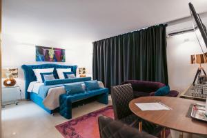 a bedroom with a blue bed and a table and chairs at BS Luxury Estate El Campello in El Campello