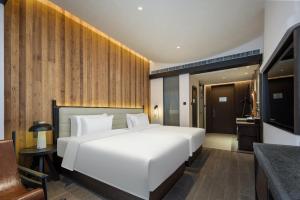 Voodi või voodid majutusasutuse Presidential Palace YiLi Hotel Nanjing toas