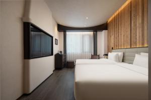 Voodi või voodid majutusasutuse Presidential Palace YiLi Hotel Nanjing toas