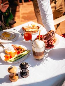 a table topped with plates of food and a drink at Domaine de l'Astragale in Saint-Tropez +37 photos