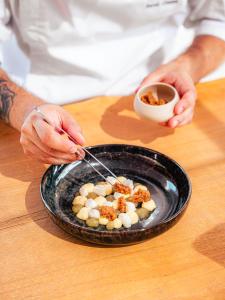 a person is eating a plate of food at Domaine de l'Astragale in Saint-Tropez