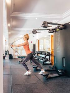 a woman exercising in a gym with a simulator at Domaine de l'Astragale in Saint-Tropez