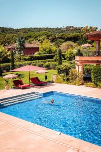 a person swimming in a swimming pool at Domaine de l'Astragale in Saint-Tropez