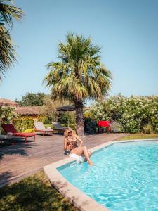 a woman is sitting in a swimming pool at Domaine de l'Astragale in Saint-Tropez