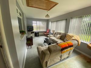 a living room with a couch and a tv at Mountain View at Grange Beg # 2 in Doonflin Lower
