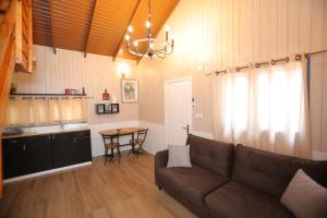 a living room with a couch and a table at אגם ריזורט בטבע in Kallanit