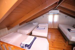 a room with three beds in a attic at אגם ריזורט בטבע in Kallanit +21 photos
