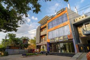 a building on a street with a dog in front of it at Majestic Hotel and Restro in Udaipur