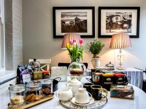 a table with jars and vases on top of it at Windsor Road Retreat in Richmond +10 photos
