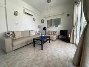 a living room with a couch and a table at Polis Chrysochous Entire Apartment in Polis Chrysochous
