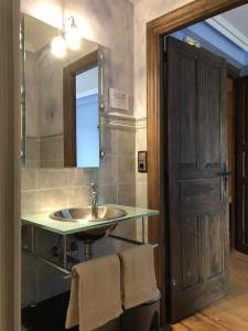 a bathroom with a sink and a mirror at Casa rural hormilla in Hormilla