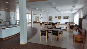 a dining room with tables and chairs in it at Majoitus Fox in Kuopio +44 photos