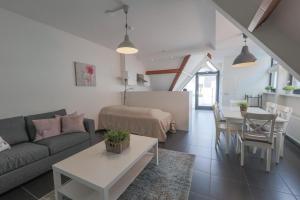 a living room with a couch and a table at Weststraat 22 - Ouddorp - Appartement Oost 3P in Ouddorp