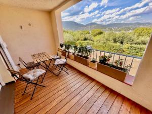 a balcony with a table and chairs and a view at Neptune in Cavalaire-sur-Mer