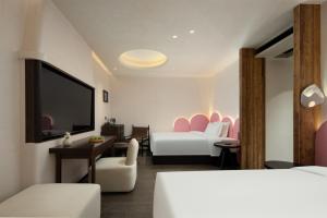 Voodi või voodid majutusasutuse Presidential Palace YiLi Hotel Nanjing toas