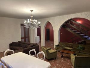 a living room with couches and a chandelier at La casa matta in Verucchio