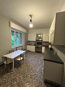 a large kitchen with a table and chairs in it at La casa matta in Verucchio