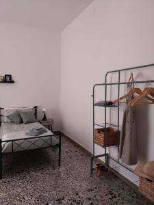 a bedroom with a bed and a rack of clothes at Sa Paxi Arbus in Arbus