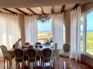 a dining room with a table and a large window at San Juan 65 in Denia