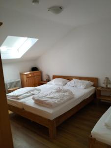 a bedroom with a large bed with a window at Fewo Schanzenblick und Fewo am Kaiser in der FWA Oberaudorf in Oberaudorf +20 photos