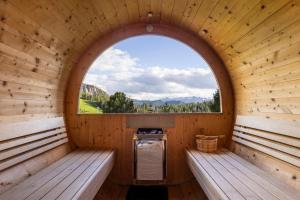 an inside view of a sauna with a window at Bio Alpine Hotel Gran Fodà in San Vigilio Di Marebbe