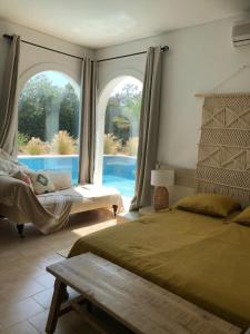 a bedroom with two beds and a view of a pool at Charming Villa Son Parc in Son Parc