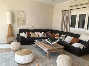 a living room with a black couch and a coffee table at Charming Villa Son Parc in Son Parc