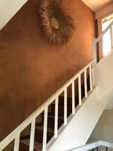 a staircase with a white rail and a brown wall at Charming Villa Son Parc in Son Parc +20 photos
