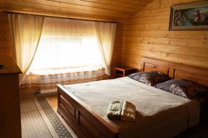 a bedroom with a bed in a wooden room at Садиба Комфорт in Slavske +86 photos
