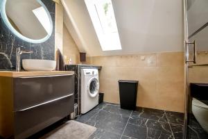a bathroom with a sink and a washing machine at Domek Pod Brzyzkiem in Białka Tatrzanska +72 photos