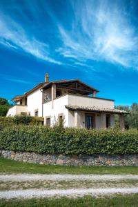 a white house on top of a hill at Poderaccio Agri Relais Apartments & Restaurant in Bolsena +73 photos