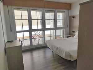Łóżko lub łóżka w pokoju w obiekcie Hotel Hórreo by Bossh! Hotels