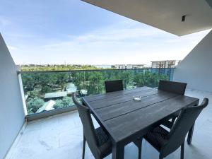 a wooden table and chairs on a balcony with a view at Wave 6 Apartments in Năvodari