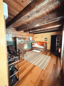 a living room with a couch and wooden ceilings at Aguilhões River House in Pedorido