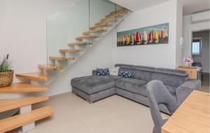 a living room with a couch and a staircase at 2 Bedroom Awesome Apartment In Nin in Nin