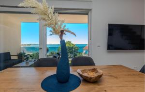 a blue vase sitting on top of a wooden table at 2 Bedroom Awesome Apartment In Nin in Nin