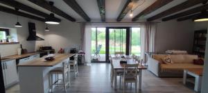 a kitchen and living room with a table and a couch at Chalupa Kadov 99 in Kadov