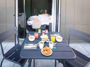 a blue table with breakfast foods and drinks on it at Tribe Paris La Defense Esplanade in Courbevoie