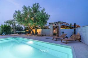 a swimming pool with two chairs and a house at Holiday home Casa LYRA with heated pool in Novigrad 800m from the beach in Novigrad Istria