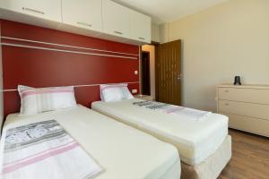 two beds sitting next to each other in a room at Swan Bay complex in Chernomorets