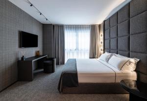 a hotel room with a bed and a television at Zeta Rentals in Bari