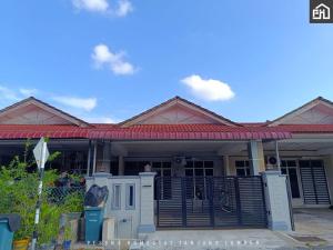 a house with a gate and a fence at Pesona Homestay Tanjung Lumpur Kuantan in Kuantan