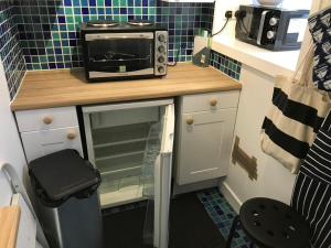 a microwave sitting on top of a counter in a kitchen at 105 Seatown in Cullen